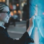 woman writing and drawing on the interactive display